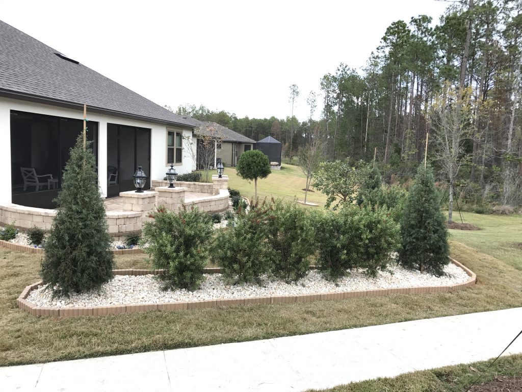 Upgraded yard with trees and stonework