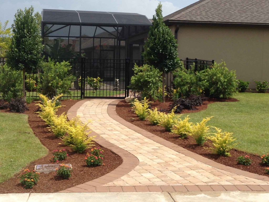 Yard with new stone walkway and gardens.