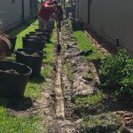 Workers digging a drain.